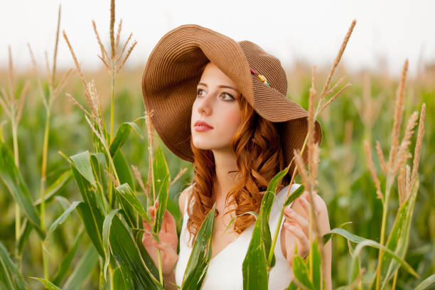 istock Young girl in hat at corn field 915229964