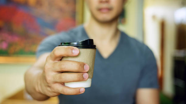 Man holding a cup of coffee.