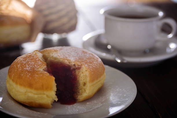 istock Berliner donut with berry jam. Close up 915230042