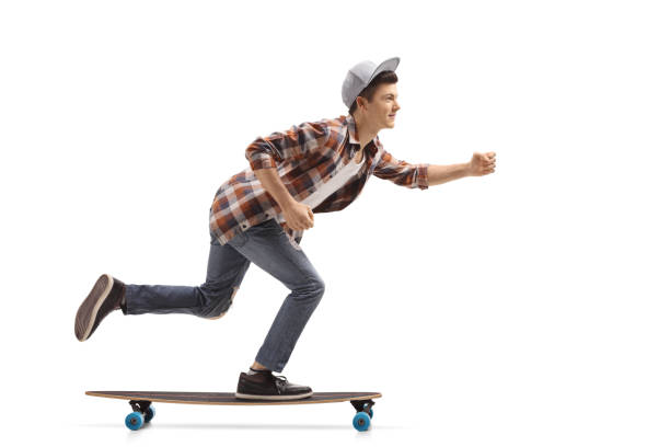 istock Teen hipster riding a longboard 915234392