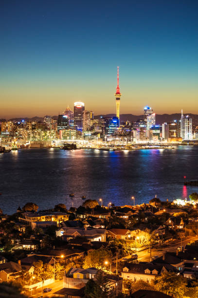 Auckland's skyline at dusk Looking acros Waitemata Harbour to Auckland's CBD skyline, with the residential neighbourhood of Devonport in the foreground. Waitemata Harbor stock pictures, royalty-free photos & images