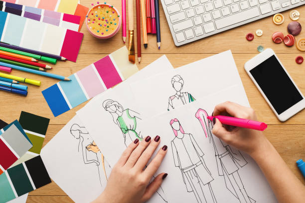 istock Top view on woman designer drawing clothes sketches 915237628