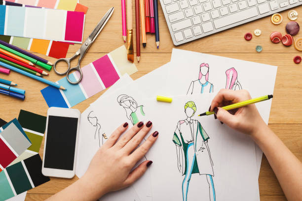 istock Top view on woman designer drawing clothes sketches 915237650