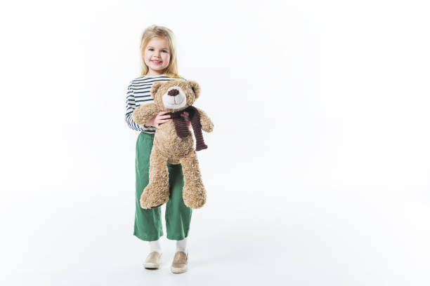 istock stylish little child with teddy bear isolated on white 915241880