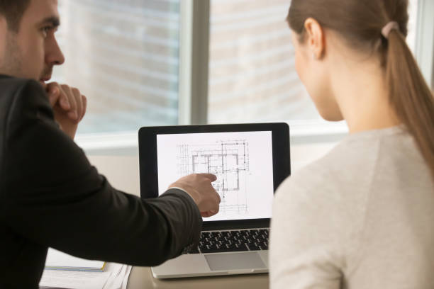 istock Businesspeople discussing home remodeling, building project plan on laptop screen 915242532