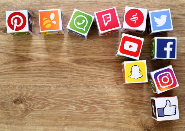 Social media cubes İstanbul, Turkey - February 6, 2018: Paper cubes with popular social media services icons, including Facebook, Instagram, Youtube, Twitter on a wooden desk. pinterest stock pictures, royalty-free photos & images