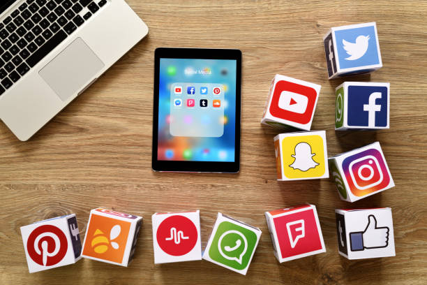 Social media cubes İstanbul, Turkey - February 6, 2018: Macbook computer, Apple iPad tablet computer and paper cubes with popular social media services icons, including Facebook, Instagram, Youtube, Twitter on a wooden desk. pinterest stock pictures, royalty-free photos & images