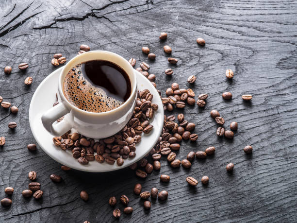 istock Cup of coffee surrounded by coffee beans. 915243588