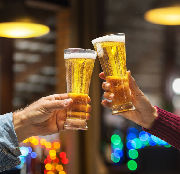 istock Beer glasses raised in a toast. 915244120