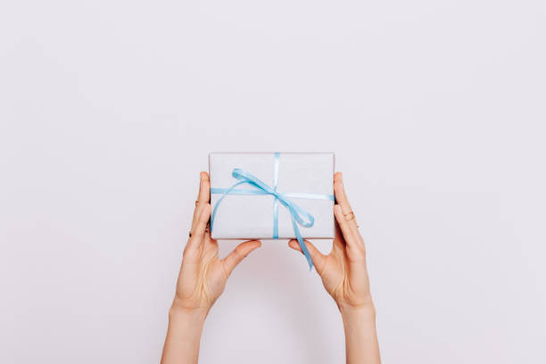 istock Blue gift box with ribbon in female hands 915247420
