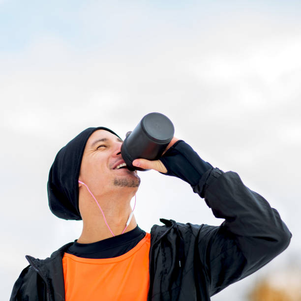 istock Young sportsman drinking water at training. 915247504
