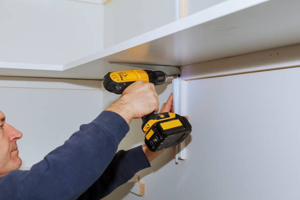 istock Profile view of a good looking handyman making some drill wall installing a shelf 915247844