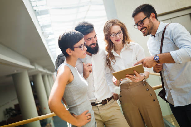 istock Happy business colleagues in modern office 915249452
