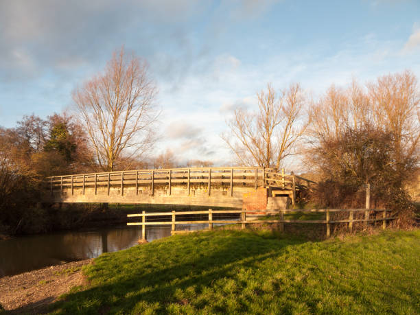 istock old wooden walking bridge over water sunset landscape 915255486