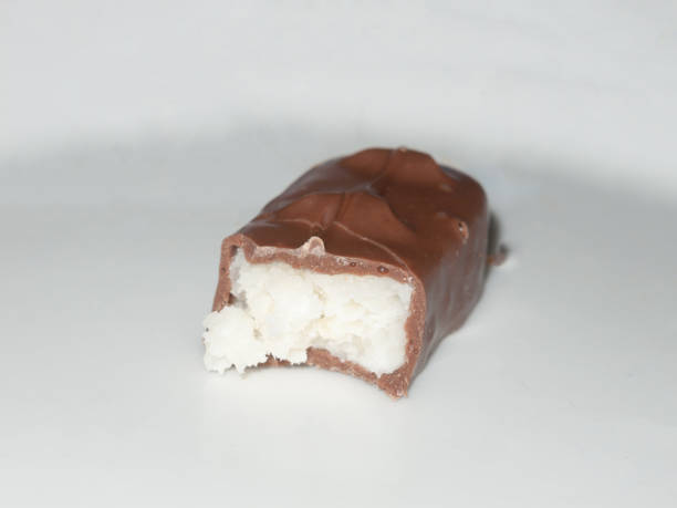 istock brown chocolate bounty bar on white surface sweets food half eaten 915255680
