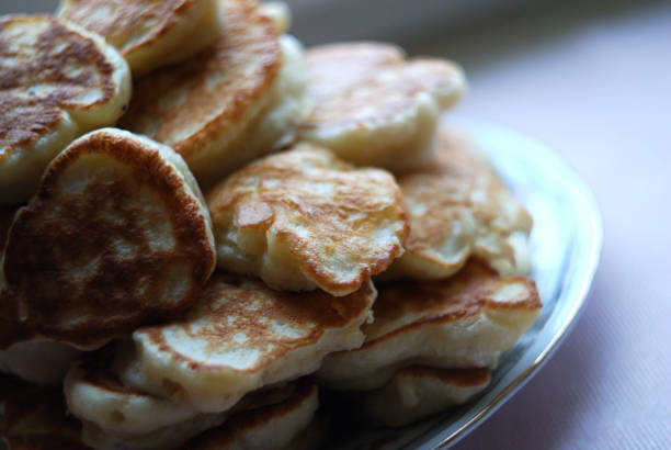 istock Russian thick pancakes piled on neutral background. 915256548