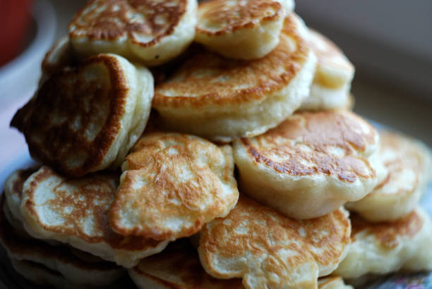 istock Russian thick pancakes piled on neutral background. 915256552