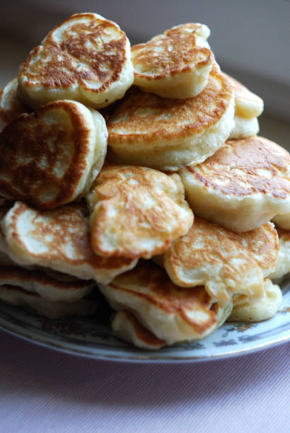 istock Russian thick pancakes piled on neutral background. 915256664
