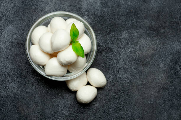 istock Traditional Italian Mozzarella cheese and basil on dark concrete 915259276