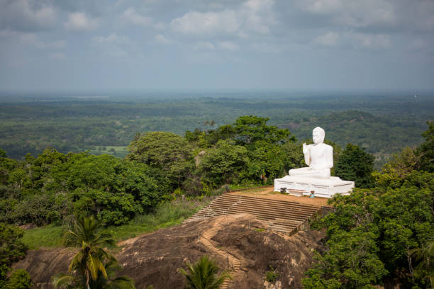 The big sculpture of the Sitting Buddha against a blue sky