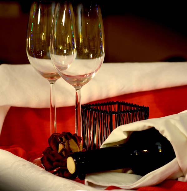 istock Wine glasses, candle, flower. Restaurant table setting. Romantic evening. Valentine's day concept. 915268192