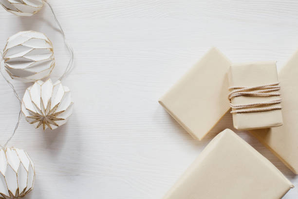 istock White and gold lanterns with boxes on white, wooden table 915268402
