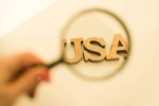 Photo of Magnifying glass on white background with the word USA