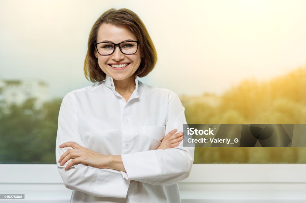 Portrait smiling medical woman doctor at Hospital Portrait smiling medical woman doctor at Hospital with a window in the background Nutritionist Stock Photo