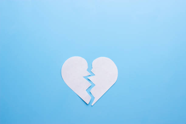 Broken heart breakup concept Broken heart on blue background. breakup concept 2273 stock pictures, royalty-free photos & images