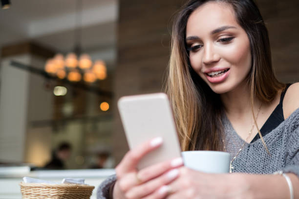 istock Pretty woman using mobile at the cafe 915276292