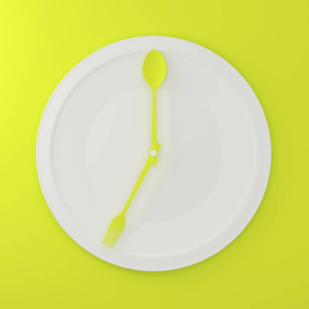 istock abstract spoon and fork on white round plate in a form of clock on green pastel background. minimal food idea concept. for produce work within an advertising marketing communications and Websites. 915276854
