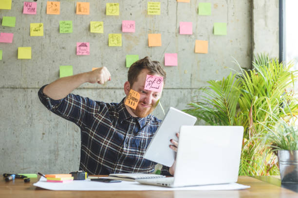 istock Stressed man with message on sticky notes over his face in office. 915276860