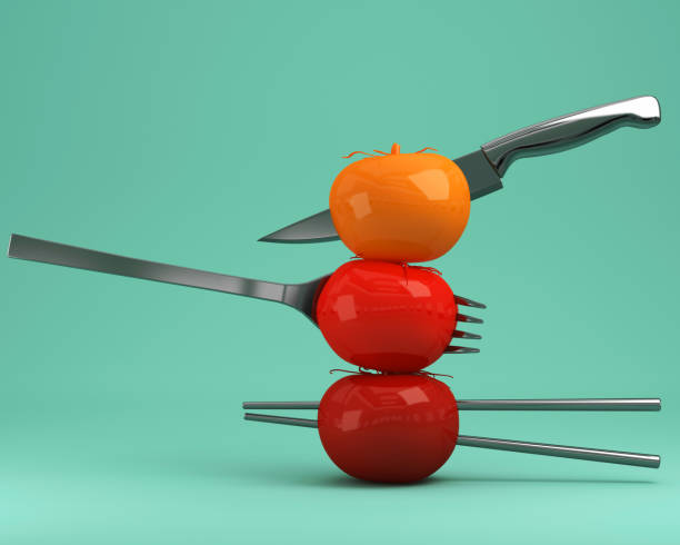 Red tomatoes impaled on kitchenware on green pastel background. minimal idea concept. creativity food is intelligence having fun for produce work within an advertising marketing communications.