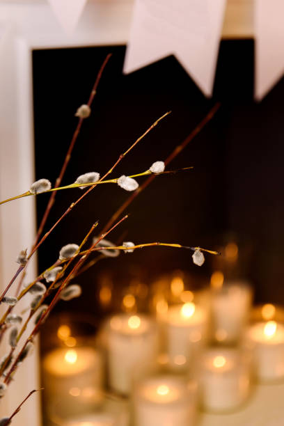 istock A close look on a pussy willow branches opposite white burning candles by the fireplace 915277490