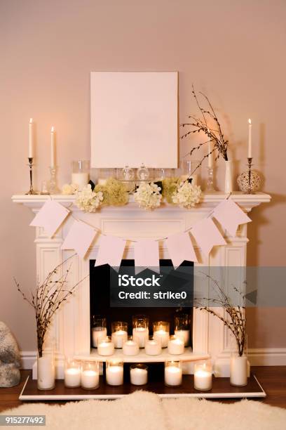 Fireplace Decorated For Easter A View On A Fair White Fireplace In Warm Candlelight Making An Easter Atmosphere With Decorations Place For Text Stock Photo - Download Image Now