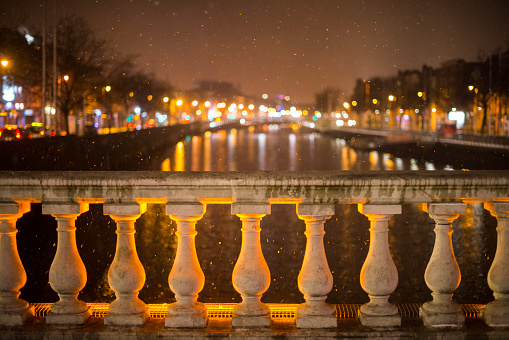 Snow falling on O'Connell Bridge over the river Liffey, Dublin, Ireland.
