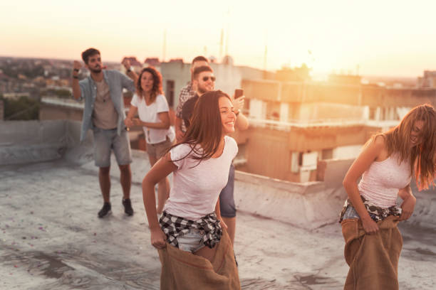 istock Summertime rooftop party sack race 915290928