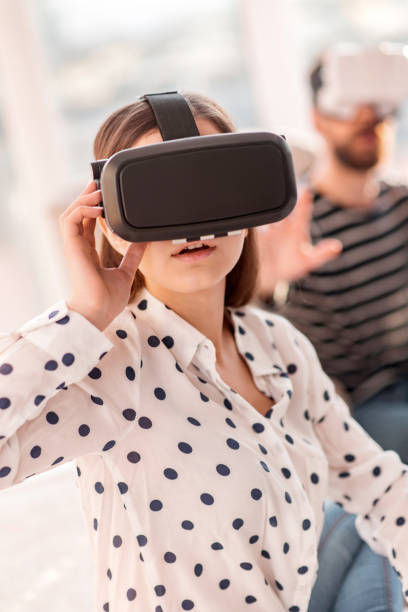 istock Pretty energetic woman powering VR glasses 915296540
