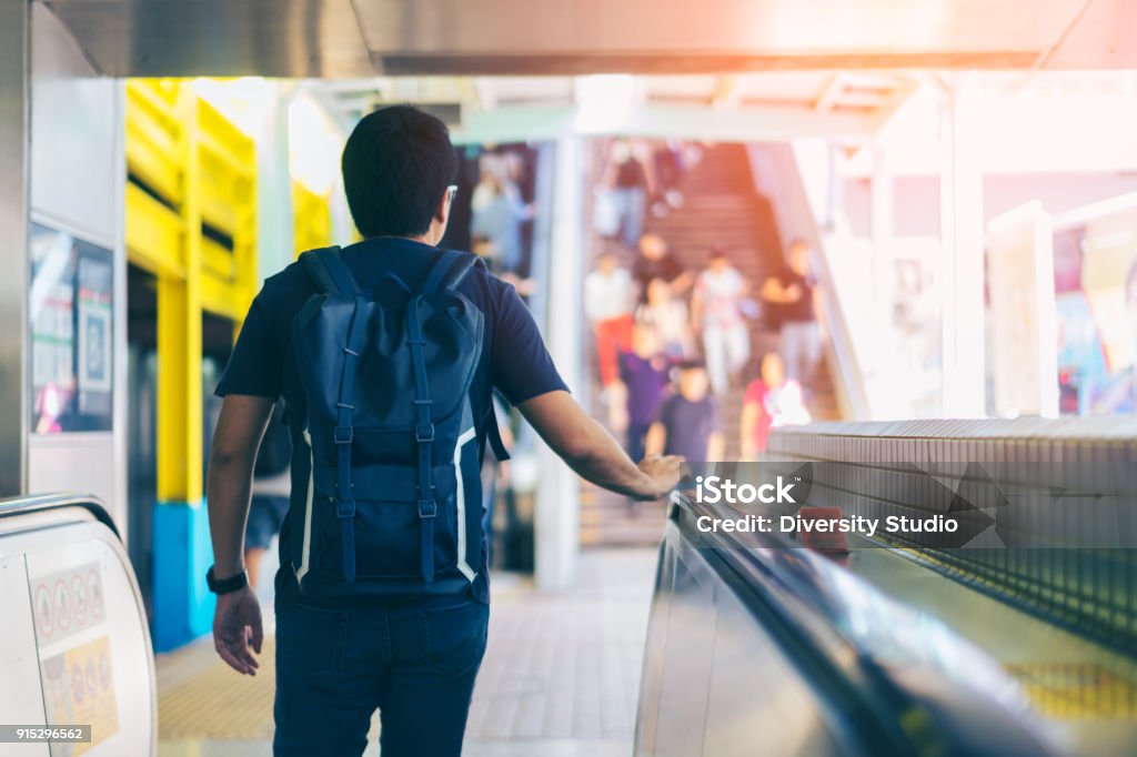 Young asian traveler walking between train station for transportation underground at Hong Kong MTR Hong Kong Stock Photo