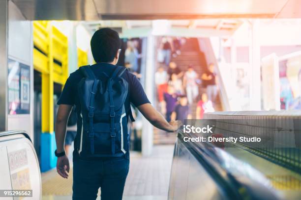 Young Asian Traveler Walking Between Train Station For Transportation Underground At Hong Kong Mtr Stock Photo - Download Image Now