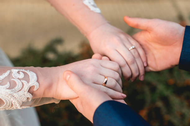 istock Loving couple holding hands with rings 915303496