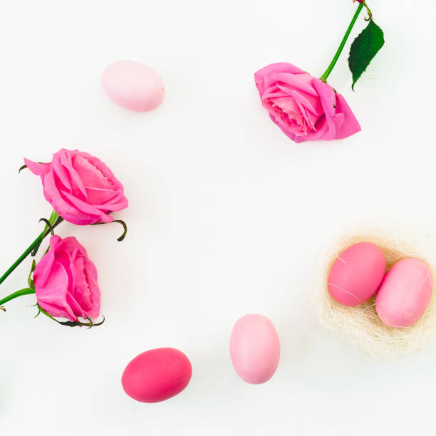 istock Pink Easter egg and quail eggs in nest and pink roses on white background. Top view, Fat lay. Easter holiday concept. 915307938