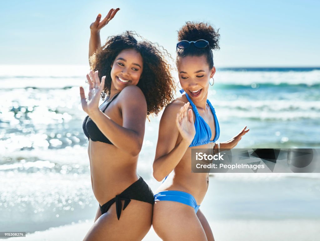 Life - live it up Shot of two happy young women having fun together at the beach Women Stock Photo