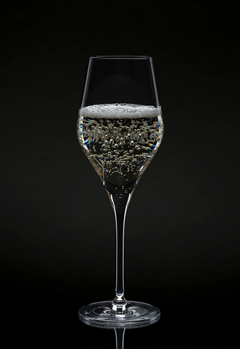 Glass of prosecco champagne on black background