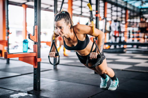 istock Woman exercising on stretching cords during cross training 915308674