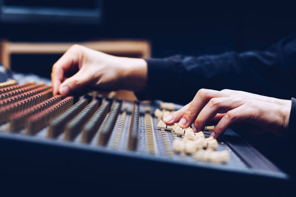 istock male sound engineer hands working on audio mixing console. music background 915311506