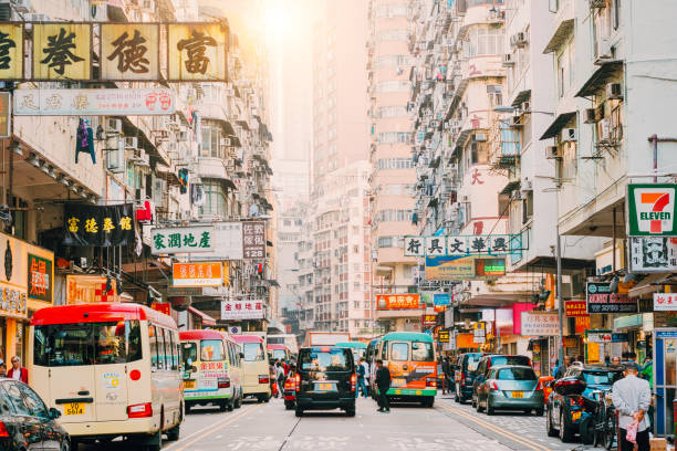Hong Kong Street Scene, Mongkok District with traffic Hong Kong Street Scene, Mongkok District with busses kowloon stock pictures, royalty-free photos & images