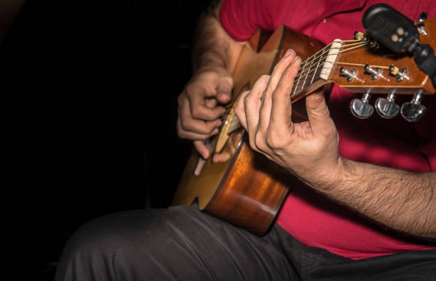 istock Man playing acoustic guitar 915315440