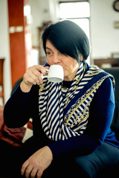 istock Beautiful mature woman with a cup 915315910