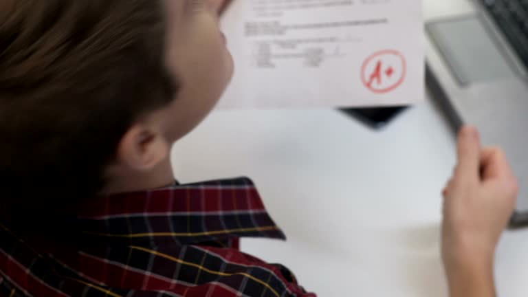 Student showing yes gesture, expressing happiness about highest grade, back view